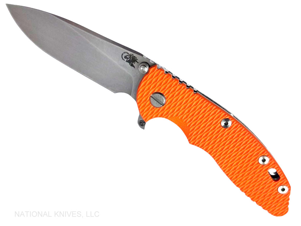 Rick Hinderer Knives XM-18 Skinny Slicer with thumb stud and flipper tab - shown open presentation side.  Stonewash Magnacut stainless steel, hollow ground, plain edge blade.  Orange G-10 handle with stonewash lock side. 