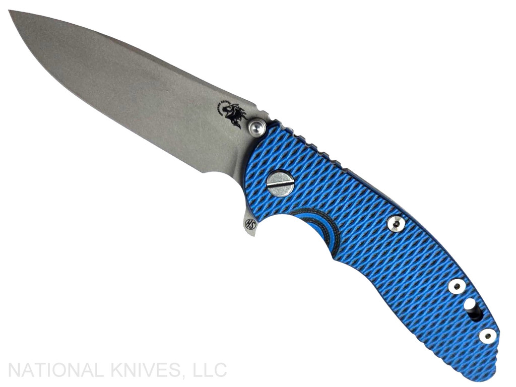 Rick Hinderer Knives XM-18 Skinny Slicer with thumb stud and flipper tab - shown open presentation side.  Working Finish Magnacut stainless steel, hollow ground, plain edge blade.  Blue - Black G-10 handle with Working Finish lock side. 