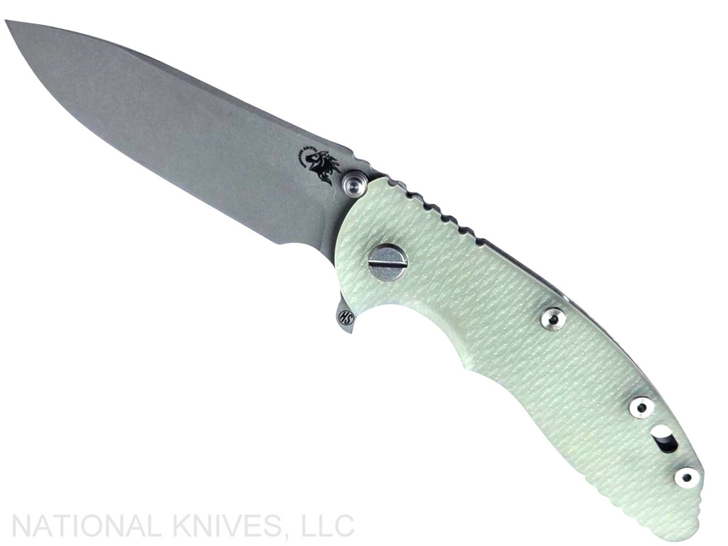 Rick Hinderer Knives XM-18 Skinny Slicer with thumb stud and flipper tab - shown open presentation side.  Working Finish Magnacut stainless steel, hollow ground, plain edge blade.  Translucent Green G-10 handle with Working Finish lock side. 