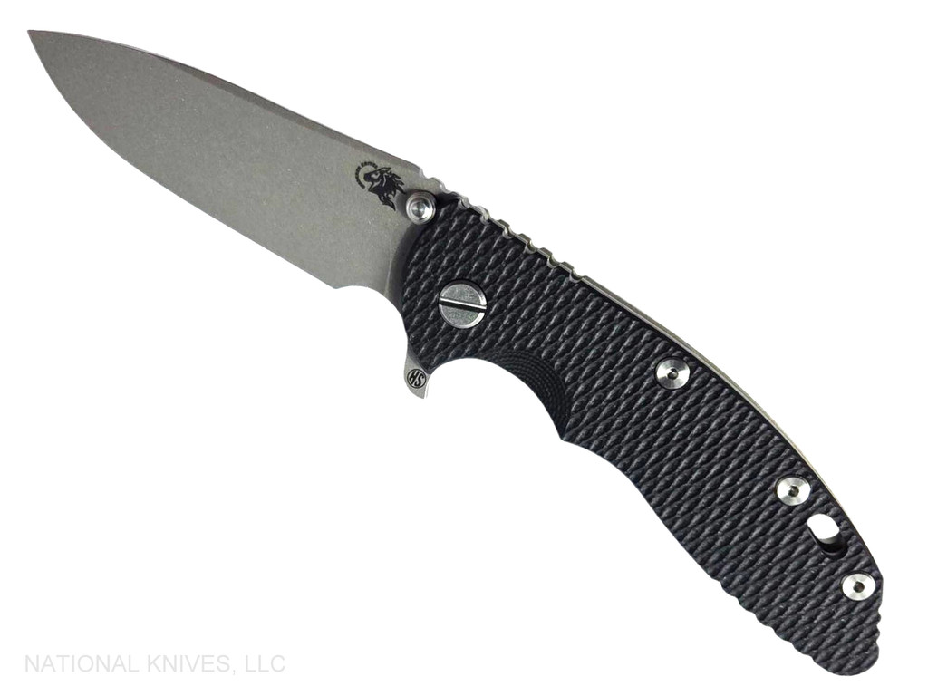 Rick Hinderer Knives XM-18 Skinny Slicer with thumb stud and flipper tab - shown open presentation side.  Working Finish Magnacut stainless steel, hollow ground, plain edge blade.  Black G-10 handle with Battle Green lock side. 
