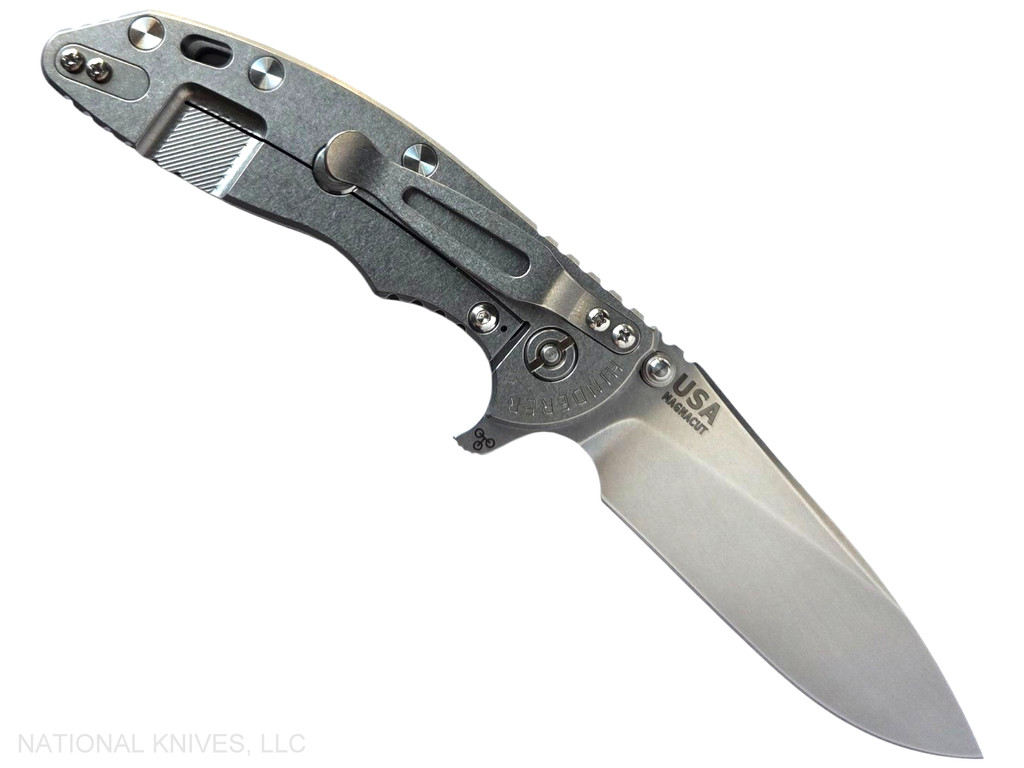 Rick Hinderer Knives XM-18 Skinny Slicer with thumb stud and flipper tab - shown open lock side.  Stonewash Magnacut stainless steel, hollow ground, plain edge blade.  OD Green G-10 handle with stonewash lock side. 