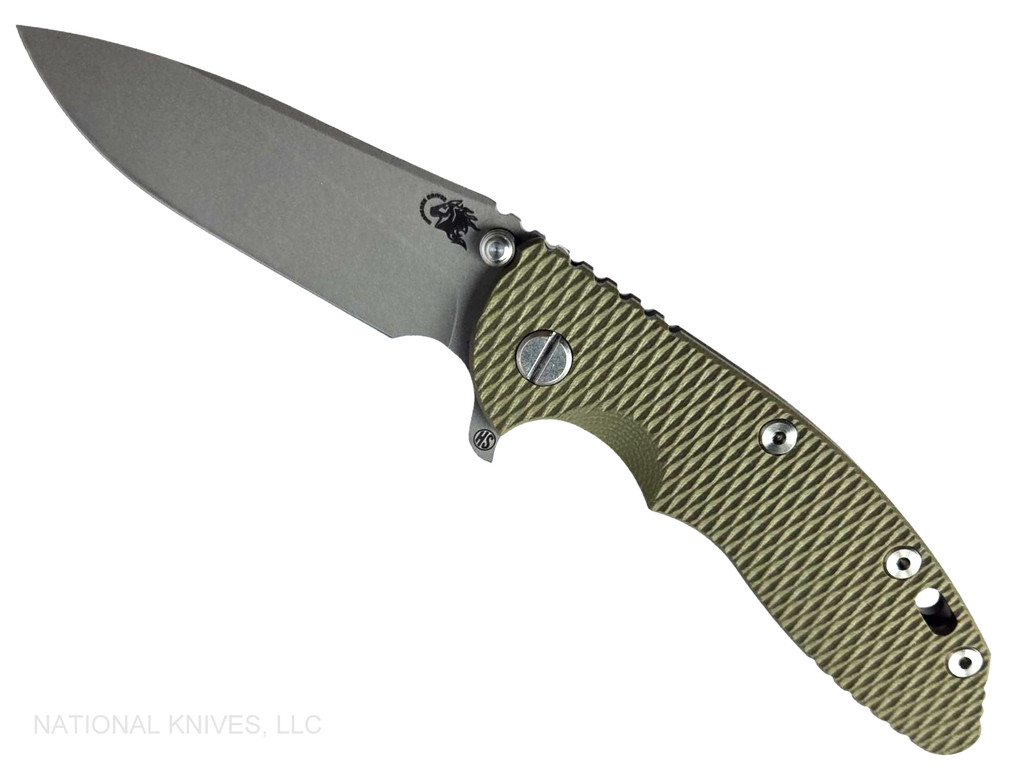 Rick Hinderer Knives XM-18 Skinny Slicer with thumb stud and flipper tab - shown open presentation side.  Working Finish Magnacut stainless steel, hollow ground, plain edge blade.  OD Green G-10 handle with Battle Bronze lock side. 