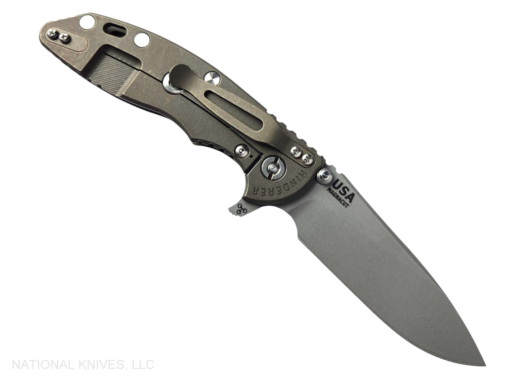 Rick Hinderer Knives XM-18 Skinny Slicer with thumb stud and flipper tab - shown open pocket clip side.  Working Finish Magnacut stainless steel, hollow ground, plain edge blade.  OD Green G-10 handle with Battle Bronze lock side. 