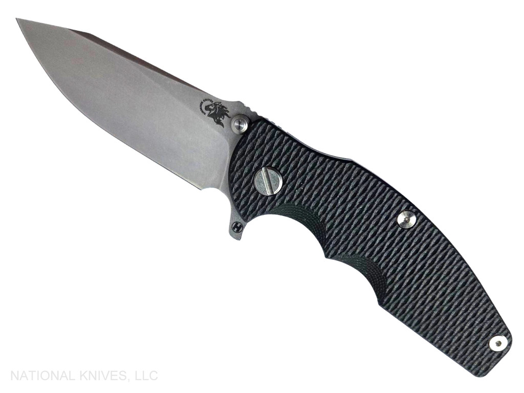 Rick Hinderer Knives Jurassic Hollow Grind Slicer folding knife with flipper tab - shown open presentation side.  Stonewash MagnaCut stainless steel plain edge blade.  Black G-10 handle scale with stonewash blue titanium lock side.  Model KJURSLHO.