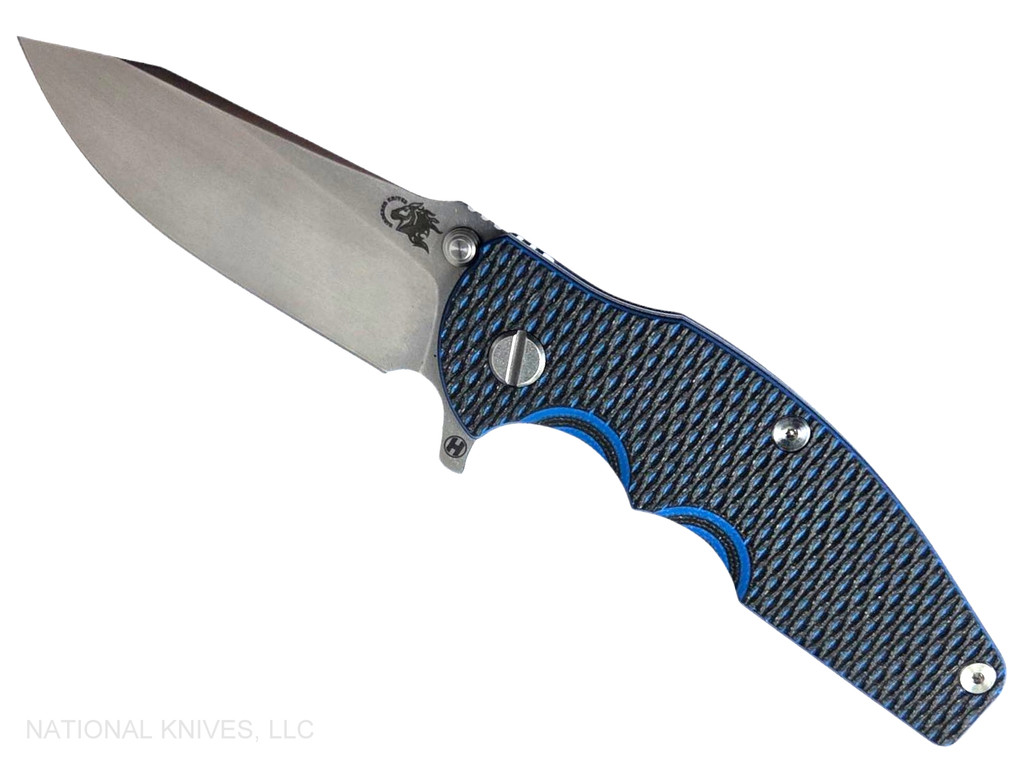 Rick Hinderer Knives Jurassic Hollow Grind Slicer folding knife with flipper tab - shown open presentation side.  Stonewash MagnaCut stainless steel plain edge blade.  Blue - black G-10 handle scale with stonewash blue titanium lock side.  Model KJURSLHO.