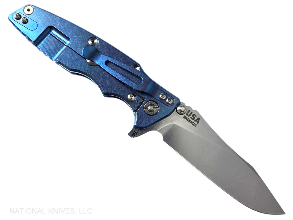Rick Hinderer Knives Skinny Eklipse Slicer folding knife with flipper tab - shown open - lock side.  Stonewash 3.5" hollow grind MagnaCut stainless steel plain edge blade.  Translucent Green G-10 handle scale with stonewashed blue lock side.  Model KEK35SKSLHO
