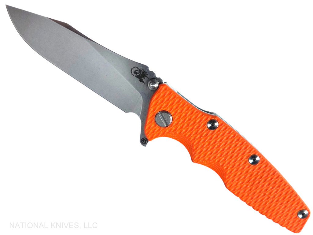 Rick Hinderer Knives Skinny Eklipse Slicer folding knife with flipper tab - shown open - presentation side.  Stonewashed 3.5" hollow grind MagnaCut stainless steel plain edge blade.  Orange G-10 handle scale with stonewash blue lock side.  Model KEK35SKSLHO