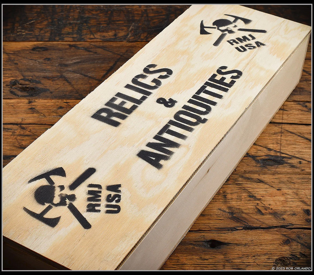 RMJ Tactical Trench Raider - Relics & Antiquities wooden box. Black Cerakote 3V steel double plain edge blade.  Black G-10 handle scales.  Model K-TR-3V-GB-BK-PB.