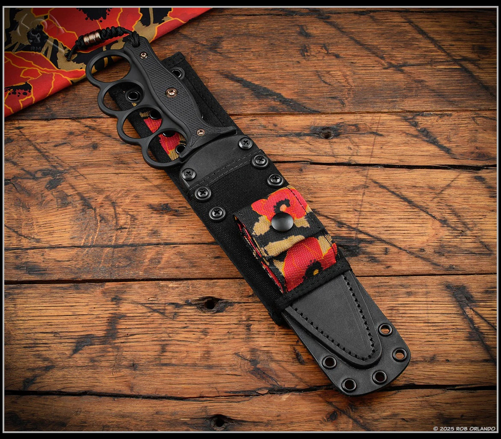 RMJ Tactical Trench Raider - shown in sheath obverse. Black Cerakote 3V steel double plain edge blade.  Black G-10 handle scales.  Model K-TR-3V-GB-BK-PB.