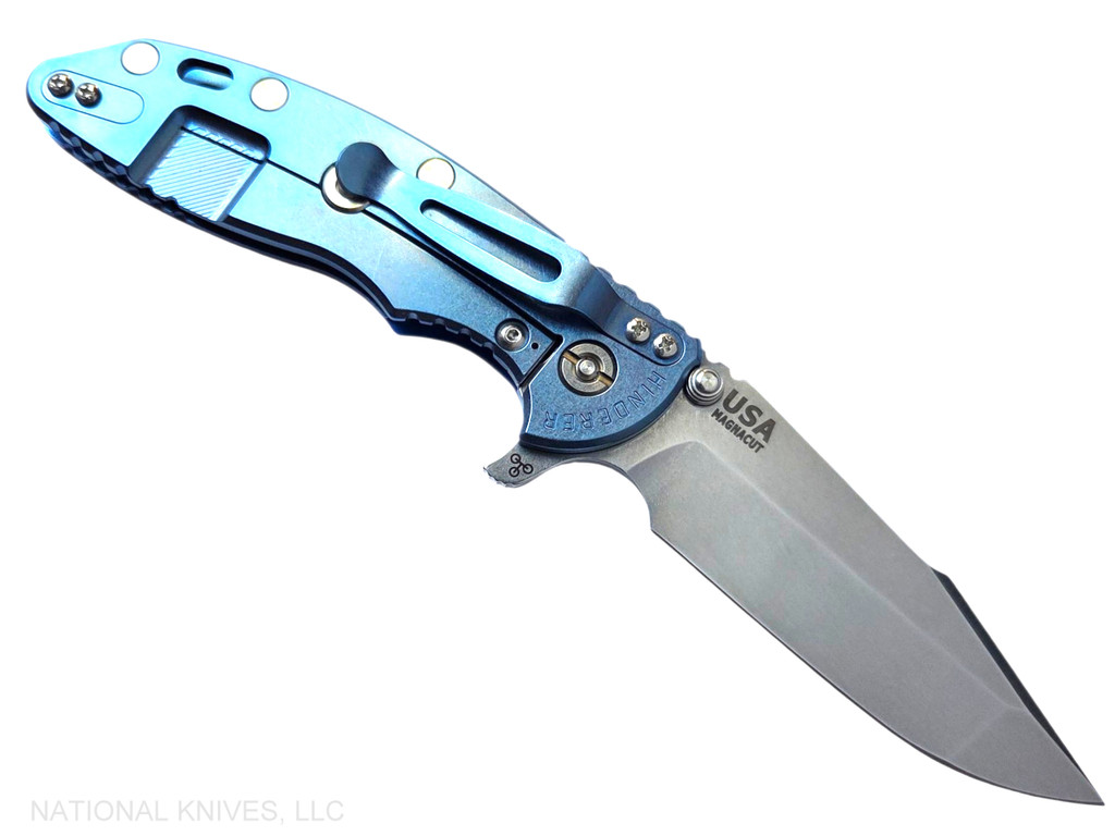Rick Hinderer Knives XM-18 Skinny Harpoon Spanto with thumb stud and flipper tab - shown open lock side.  Stonewash MagnaCut stainless steel plain edge blade.  Blue - black G-10 handle with stonewash blue lock side.  Model KXM35SKHS.