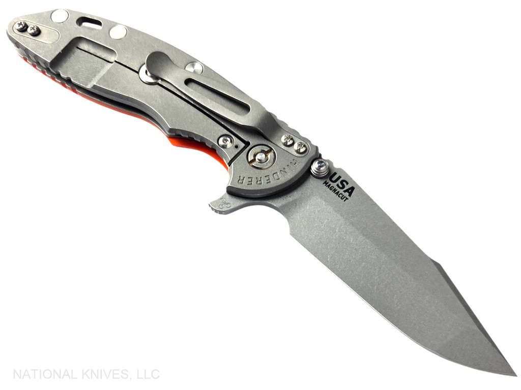 Rick Hinderer Knives XM-18 Skinny Harpoon Spanto with thumb stud and flipper tab - shown open lock side.  Working Finish MagnaCut stainless steel plain edge blade.  Orange G-10 handle with Working Finish lock side.  Model KXM35SKHS.