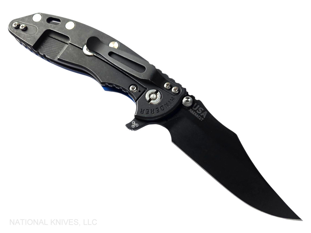 Rick Hinderer Knives XM-18 3.5" Bowie folding knife with thumb stud and flipper tab - shown open lock side.  Battle Black MagnaCut stainless steel plain edge blade.  Blue G-10 handle with Battle Black lock side.  Model KXM35BOWMC.