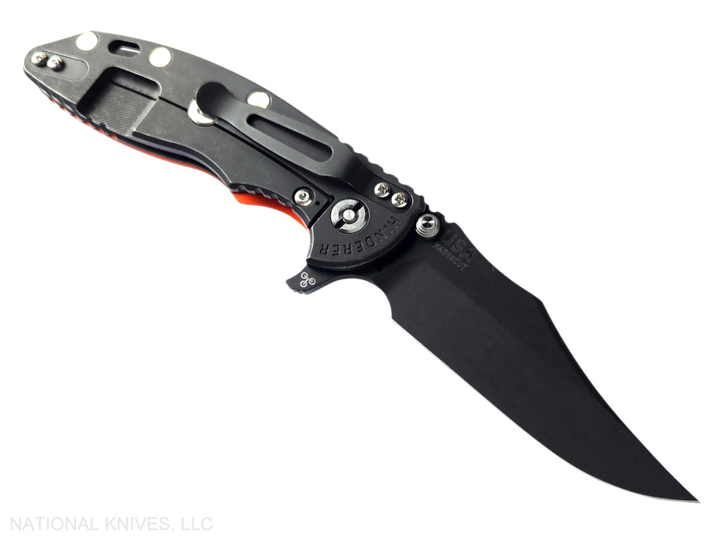 Rick Hinderer Knives XM-18 3.5" Bowie folding knife with thumb stud and flipper tab - shown open lock side.  Battle Black MagnaCut stainless steel plain edge blade.  Orange G-10 handle with Battle Black lock side.  Model KXM35BOWMC.