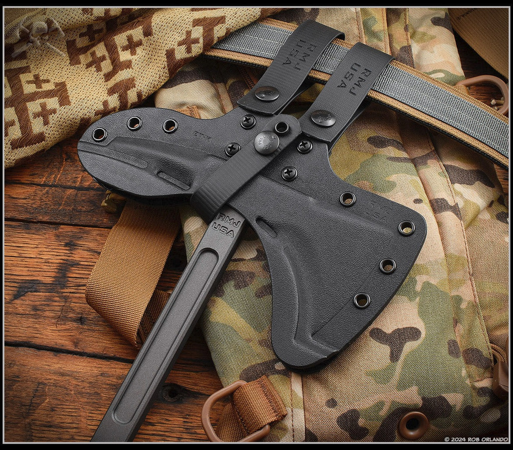 RMJ Tactical Eagle Talon limited edition tomahawk - shown close up of head in sheath obverse.  Tungsten Cerakote S7 steel plain edge head.  Dirty Olive G-10 handle.  Model T-ET-S7-TU-DO.