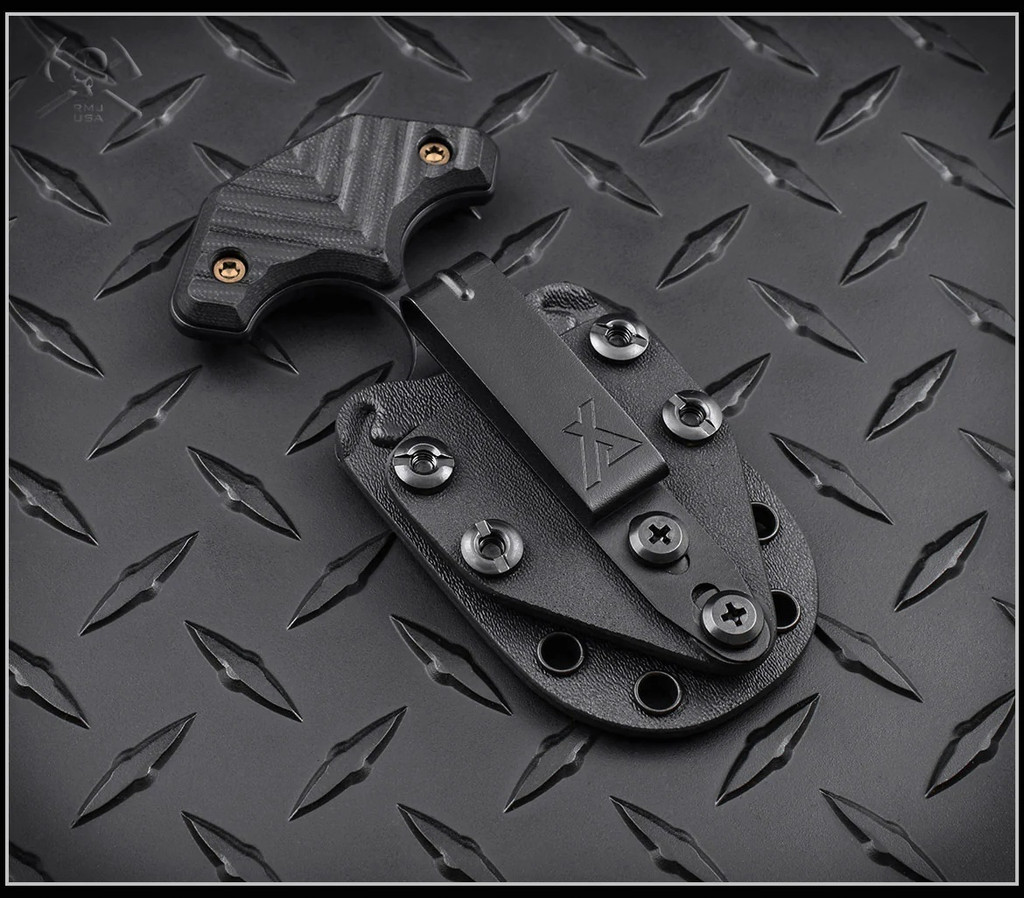 RMJ Tactical BUB Back Up Blade fixed blade knife - shown in sheath reverse.  Textured Graphite Black Cerakote MagnaCut stainless steel plain double edge blade.  Black G-10 handle.  Model K-BUB-MC-BT-BK.