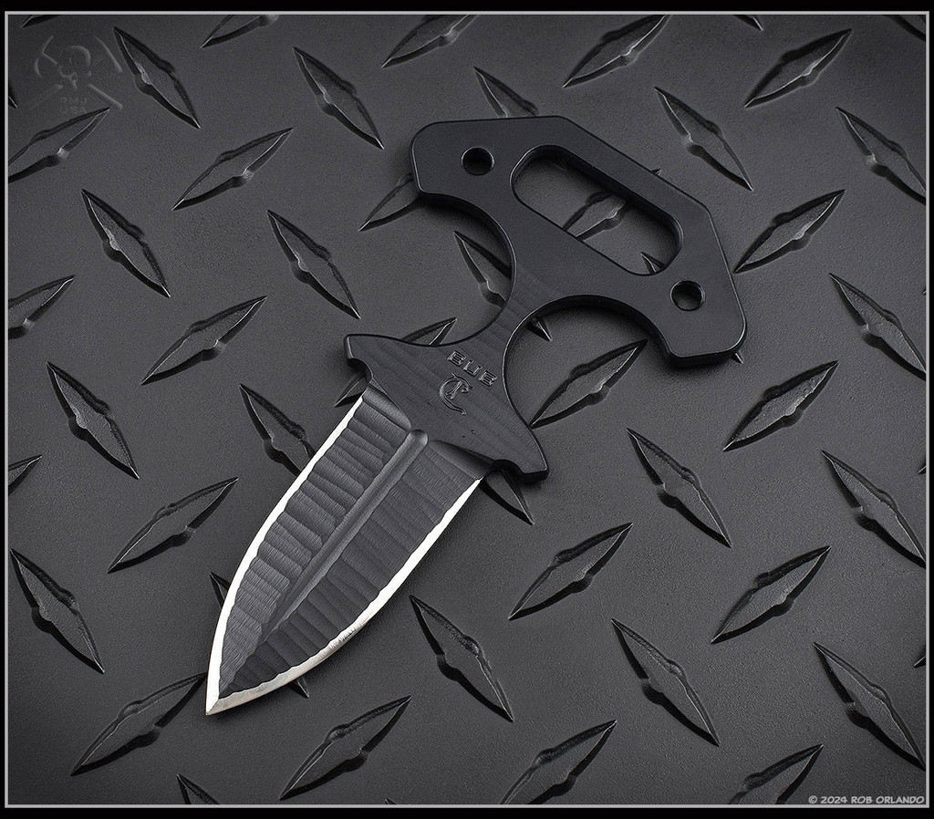 RMJ Tactical BUB Back Up Blade fixed blade knife - shown out of sheath obverse with G-10 handles removed.  Textured Graphite Black Cerakote MagnaCut stainless steel plain double edge blade.  Black G-10 handle.  Model K-BUB-MC-BT-BK.