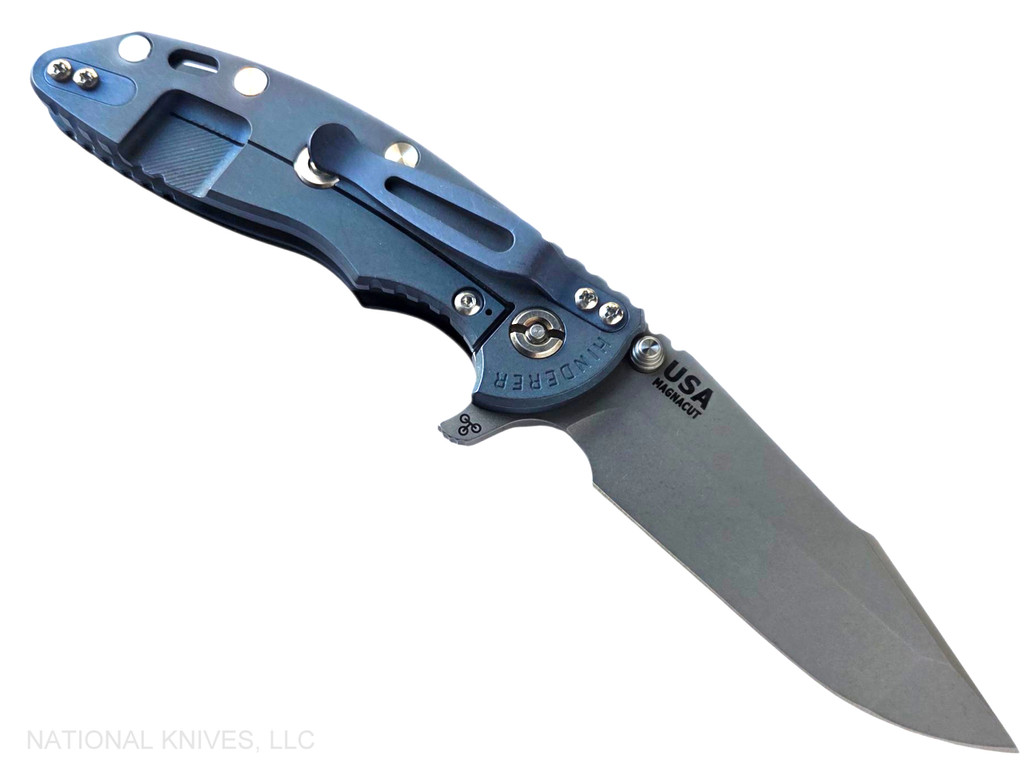 Rick Hinderer Knives XM-18 3.5" Harpoon Spanto folding knife with thumb stud and flipper tab - shown open lock side.  Working Finish MagnaCut stainless steel plain edge blade.  Black G-10 handle with Battle Blue lock side.  Model KXM35HS.