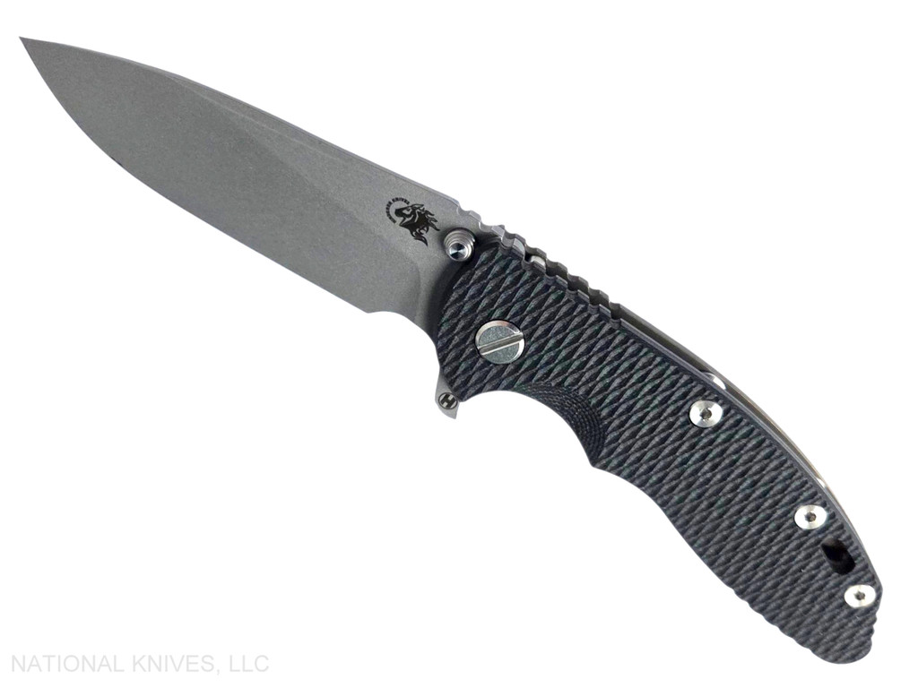Rick Hinderer Knives XM-18 3.5" Slicer Hollow Grind folding knife with thumb stud and flipper tab - shown open presentation side.  Working Finish 20CV stainless steel plain edge blade.  Black G-10 handle with Battle Bronze lock side.  Model KXM35SLHO.