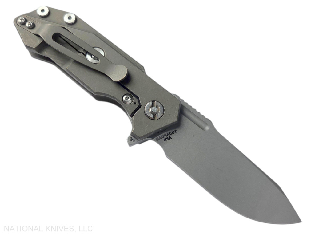 Rick Hinderer Knives Half Track Slicer folding knife with flipper tab - shown open lock side.  Working Finish MagnaCut stainless steel plain edge blade.  Black G-10 handle with Battle Bronze titanium lock side.  Model KHTSLI.