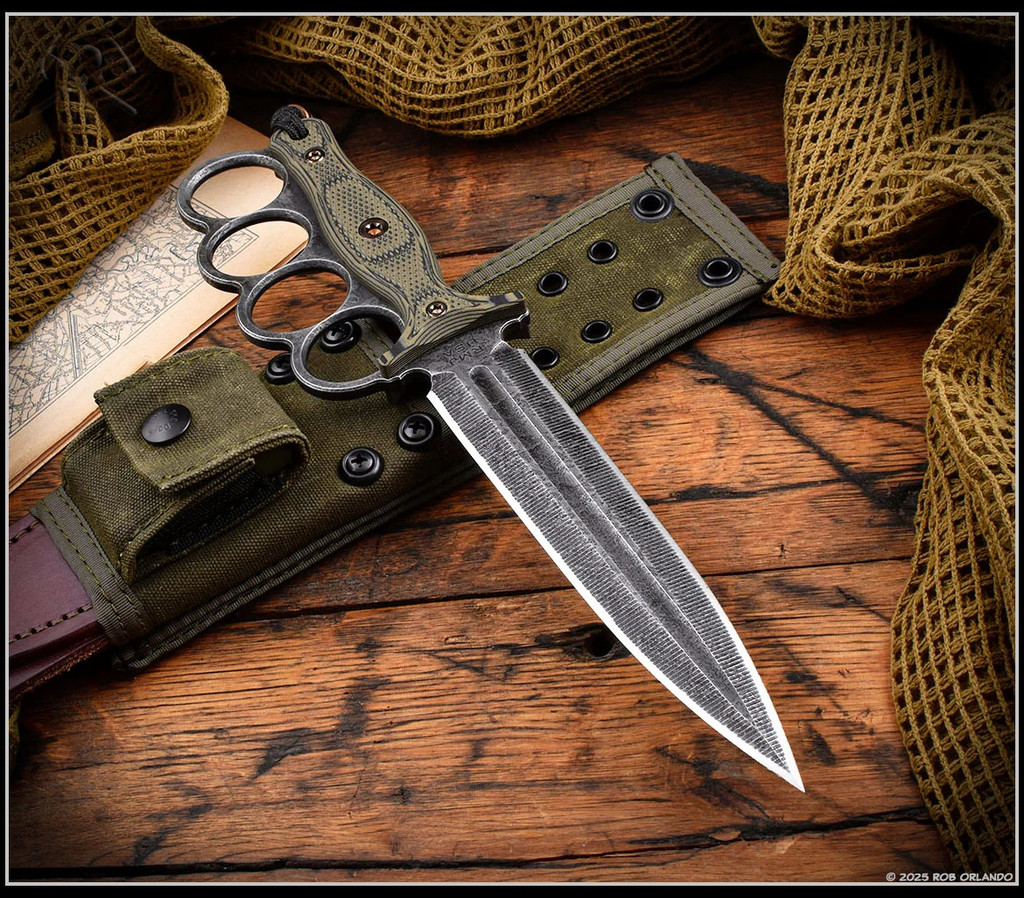 RMJ Tactical Trench Raider - shown out of sheath obverse. Acid Etch 3V steel double plain edge blade.  Dirty Olive G-10 handle scales.  Model K-TR-3V-GB-DO-OX.