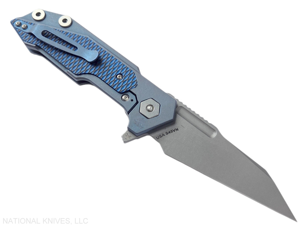 Rick Hinderer Knives Full Track Wharncliffe folding knife with flipper tab - shown open lock side.  Working Finish S45VN stainless steel plain edge blade.  Battle Blue titanium with blue - black G-10 scales.  Model KFTRWC.