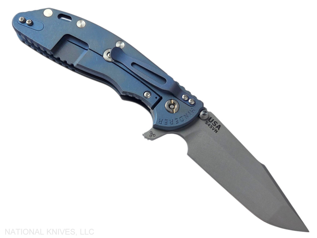 Rick Hinderer Knives XM-24 Harpoon Spanto folding knife with thumb stud and flipper tab - shown open lock side.  Working Finish S45VN stainless steel plain edge blade.  Black G-10 handle with Battle Blue lock side.  Model KXM40HS.