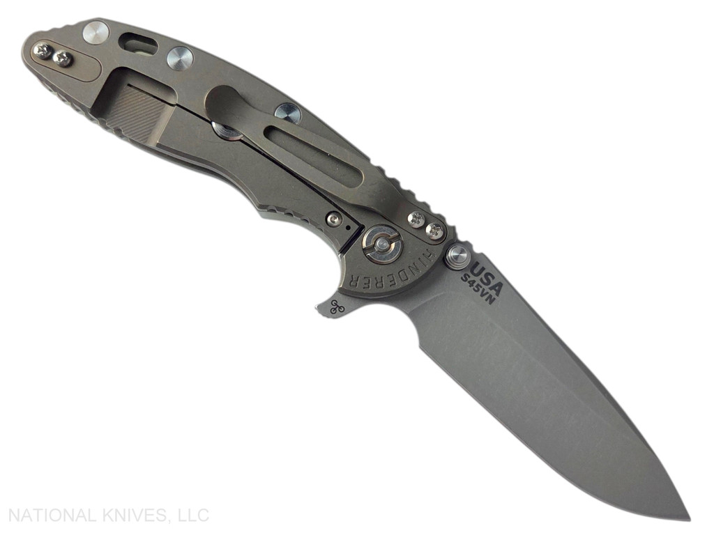 Rick Hinderer Knives XM-18 3.25" Spear Point folding knife with thumb stud and flipper tab - shown open lock side.  Working Finish S45VN stainless steel plain edge blade.  Translucent Green G-10 handle with Battle Bronze lock side.  Model KXM325SPE.
