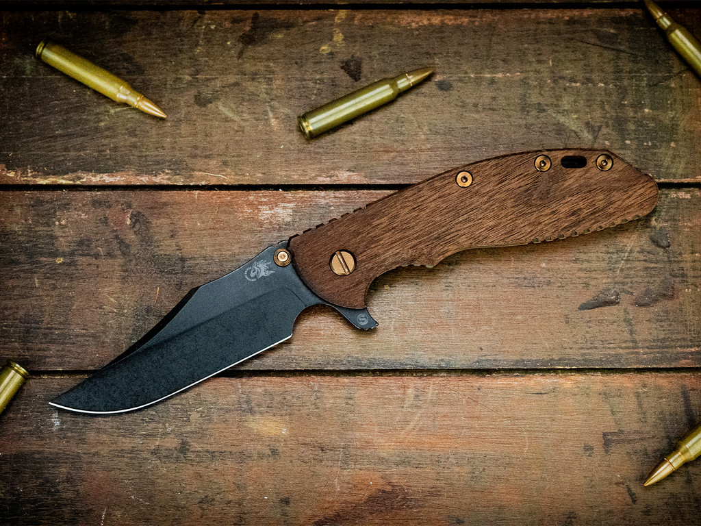 Rick Hinderer Knives XM-24 Vintage Skinny Bowie folding knife with thumb stud and flipper tab - shown open presentation side.  Parkerized 1095 tool steel plain edge blade.  Smooth Walnut handle with Battle Green lock side.  Model KXM40SKBO.