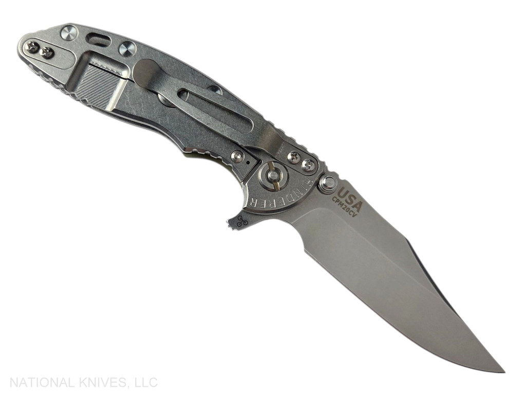 Rick Hinderer Knives XM-18 3.0" Bowie folding knife with thumb stud and flipper tab - shown open lock side.  Stonewash 20CV stainless steel plain edge blade.  OD green G-10 handle with stonewashed lock side.  Model KXM30BOW.