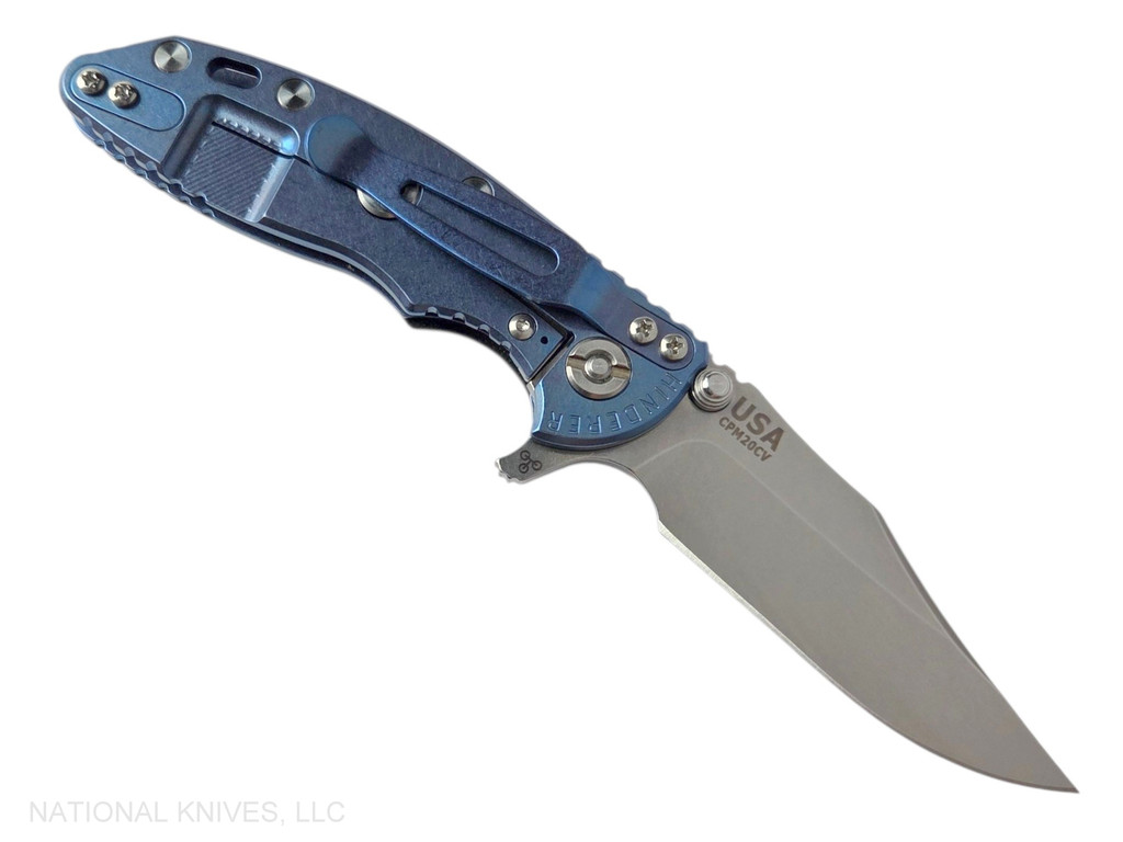 Rick Hinderer Knives XM-18 3.0" Bowie folding knife with thumb stud and flipper tab - shown open lock side.  Stonewash 20CV stainless steel plain edge blade.  Black G-10 handle with stonewashed blue lock side.  Model KXM30BOW.