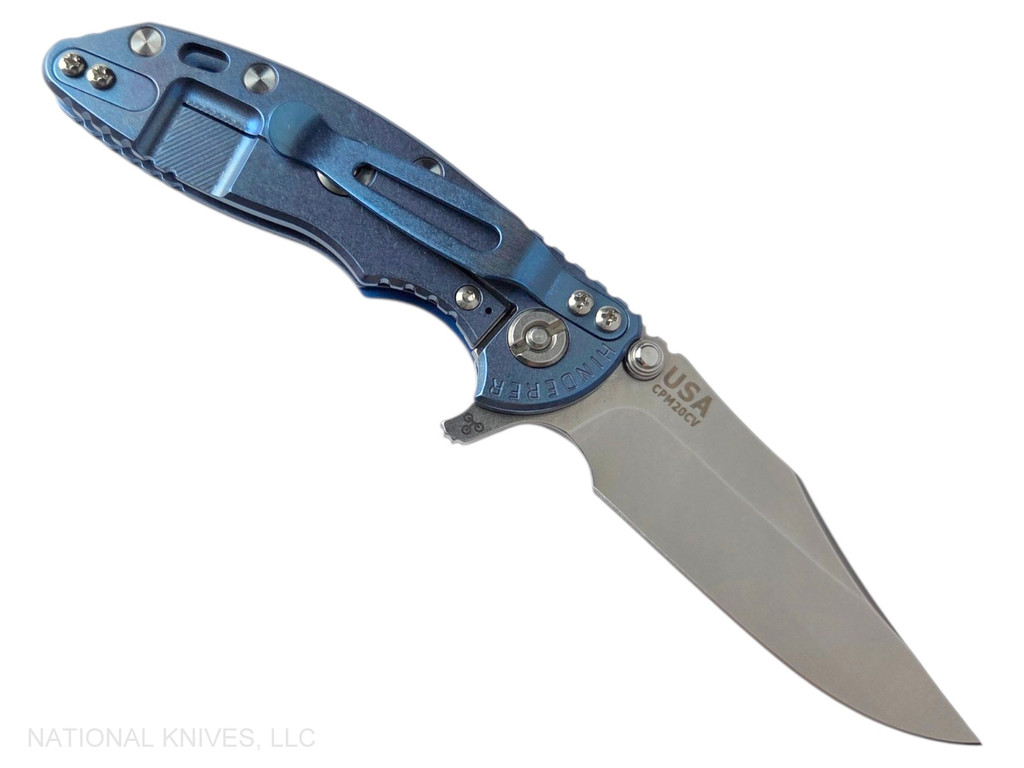 Rick Hinderer Knives XM-18 3.0" Bowie folding knife with thumb stud and flipper tab - shown open lock side.  Stonewash 20CV stainless steel plain edge blade.  Blue - black G-10 handle with stonewashed blue lock side.  Model KXM30BOW.