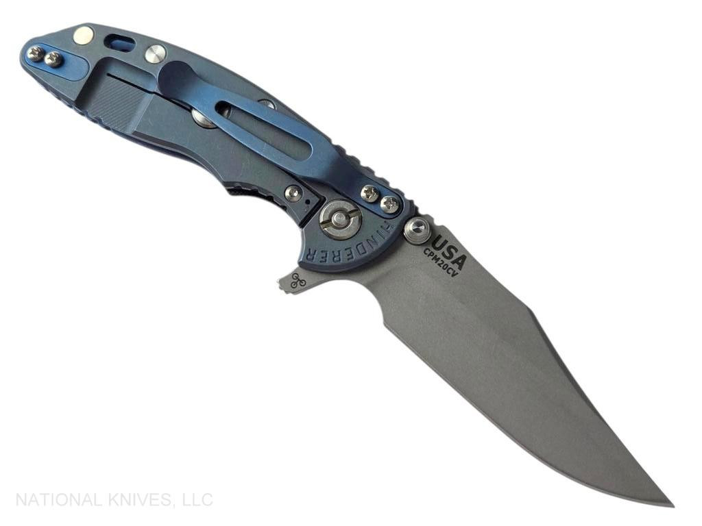 Rick Hinderer Knives XM-18 3.0" Bowie folding knife with thumb stud and flipper tab - shown open lock side.  Working Finish 20CV stainless steel plain edge blade.  Black G-10 handle with Battle Blue lock side.  Model KXM30BOW.