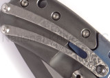 Todd Begg Knives Bodega 2.0 folding knife with flipper tab - shown close up of pocket clip.  2-tone N690 stainless steel plain edge blade.  Blue titanium handle.
For reference only.