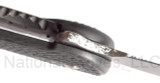 Todd Begg Knives Bodega Field Grade folding knife with flipper tab - shown close up of lock.  2-tone N690 stainless steel plain edge blade.  Carbon fiber handle.
For reference only.