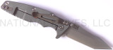 Rick Hinderer Knives Eklipse Tanto folding knife with thumb stud and flipper tab - shown open lock side.  Stonewash S35VN stainless steel plain edge blade.  Black G-10 handle with Working Finish lock side.  Model K40040TD00.
For reference only.