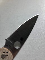 Used Spyderco Native Chief folding knife with thumb hole - close up of presentation side blade shown.  Satin Cru-Wear steel plain edge blade.  Brown Micarta handle.  Model C244MPCW.