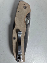 Used Spyderco Native Chief folding knife with thumb hole - shown closed pocket clip side. Satin Cru-Wear steel plain edge blade. Brown Micarta handle. Model C244MPCW. Used Spyderco Native Chief folding knife with thumb hole - shown closed pocket clip side. Satin Cru-Wear steel plain edge blade. Brown Micarta handle. Model C244MPCW.