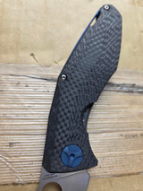 Used Spyderco Drunken folding knife with thumb hole - close up of presentation side handle shown.  Satin S90V stainless steel plain edge blade.  Black carbon fiber handle with titanium lock side.  Model C235CFTIP.