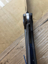Used Spyderco Drunken folding knife with thumb hole - close up of lock shown.  Satin S90V stainless steel plain edge blade.  Black carbon fiber handle with titanium lock side.  Model C235CFTIP.