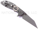 Rick Hinderer Knives Gearhead XM-24 Wharncliffe folding knife with thumb stud and flipper tab - shown open lock side.  Working Finish M390 stainless steel plain edge blade.  FDE G-10 handle with Working Finish lock side.  Model K3023SGW00.
For reference only.