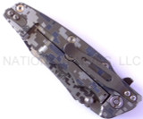Rick Hinderer Knives Digi Camo Edition Eklipse Harpoon Tanto folding knife with thumb stud and flipper tab - shown closed lock side.  Working Finish 20CV stainless steel plain edge blade.  Black G-10 handle with Battle Bronze lock side.  Model K40042S000.
For reference only.