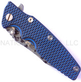 Rick Hinderer Knives Digi Camo Edition Eklipse Harpoon Tanto folding knife with thumb stud and flipper tab - shown closed presentation side.  Working Finish 20CV stainless steel plain edge blade.  Blue - black G-10 handle with Battle Blue lock side.  Model K40042S000.
For reference only.