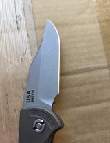 USED Rick Hinderer Knives XM-18 Automatic Bowie knife with push button - shown open pocket clip side blade.  Working Finish S45VN stainless steel plain edge blade.  Battle Bronze titanium handle. 