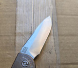 USED Rick Hinderer Knives XM-18 Automatic Spearpoint knife with push button - close up of pocket clip side blade shown.  Stonewash 20CV stainless steel plain edge blade.  Anodized bronze titanium handle. 
