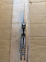 USED Rick Hinderer Knives XM-18 Automatic Spearpoint knife with push button - close up of bottom view of handle.  Stonewash 20CV stainless steel plain edge blade.  Anodized bronze titanium handle. 