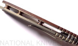 Rick Hinderer Knives Vintage Series XM-18 3.5" Spear Point folding knife with thumb stud and flipper tab - shown open close up of handle.  Black O-1 steel plain edge blade.  Smooth Walnut handle with Battle Green lock side.  Model K2082SWPK.
For reference only.