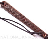 RMJ Tactical Custom Valhalla Kestrel Tomahawk with Triskelle pattern - close up of obverse handle.  80CRV2 steel plain edge head.  Brown Micarta handle scales.  
For reference only.