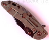 Rick Hinderer Knives Vintage Series XM-18 3.5" Bowie folding knife with thumb stud and flipper tab - shown closed lock side.  Black O-1 steel plain edge blade.  Smooth Walnut handle with Battle Green titanium lock side.  Model K2032S0VT.
For reference only.