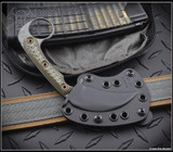 RMJ Tactical Korbin Karambit fixed blade knife - shown in sheath obverse.  Tungsten Cerakote Nitro-V stainless steel plain edge blade.  Dirty Olive G-10 handle.  Model K-KO-TU-DO.