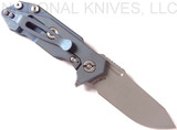 Rick Hinderer Knives Half Track Slicer folding knife with flipper tab - shown open lock side.  Stonewash 20CV stainless steel plain edge blade.  Black G-10 handle with Battle Blue titanium lock side.  Model K2009SGS00.